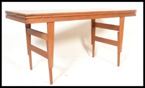 A stunning mid 20th Century teak wood Danish adjustable metamorphic dining / coffee table,