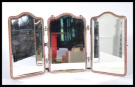 An early 20th Century triptych mirror constructed from three bevelled glass panels mounted in a