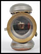A early 20th Century bicycle lamp by Joseph Lucas captain, having magnifying lens and green/red side