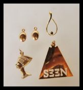 A collection of 9ct gold pendants to include two coffee bean pendants, a twist decoration pendant