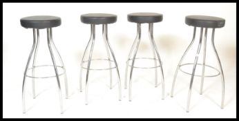 A set of 4 modernist chrome bar stools. Each stool with tubular chrome frames having foot peripheral