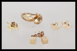 A selection of 9ct gold ladies stud earrings to include crucifix earrings, snake design earrings,