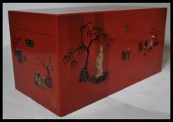 A large decorative 20th century Red lacquer Chinese chest / trunk. The red painted body with