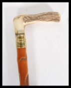A 20th Century walking sword stick cane having bone crook handle with with brass banding. Handle
