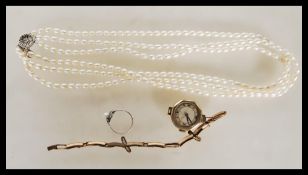 A small group of vintage jewellery to include, a three string cultured pearl necklace having