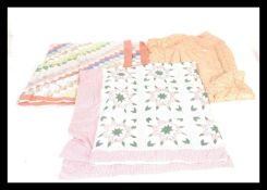 A collection of three vintage 20th Century quilts / bed throws to include an eider down filled quilt