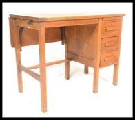 A mid 20th century retro oak air ministry desk, having a bank of drawers to the right and a drop