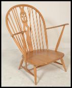 A vintage 20th century Ercol Golden Dawn beech and elm wood Windsor /armchair raised on turn legs