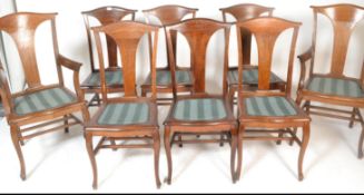 A set of 8 1920's oak dining chairs. Raised on shaped legs with overstuffed drop in seats having