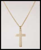 A stamped 9ct gold necklace chain having a hallmarked 9ct gold crucifix pendant. Hallmarked