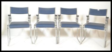 A set of 4 contemporary modernist chrome stacking dining chairs. Each with modern padded seats and