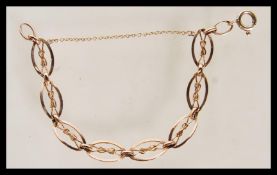 A stamped 9ct gold link  bracelet, each link stamped 9ct with a central bow to each. Weight 6.56g