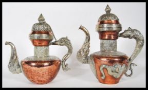 A pair of similar 20th Century middle eastern brass and copper kettles, having dragon style