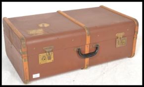 A vintage 20th Century canvas and cane bound steamer trunk, hinged top with latches to the front and