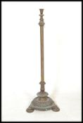 An early 20th Century brass and copper standard lamp, having flared top on corinthian style column