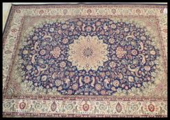 A large Persian floor carpet Keshan rug having a blue ground with geometric borders and