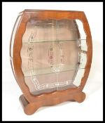 A 20th Century 1950's Art Deco walnut china display cabinet having sliding glass doors, with glass