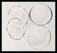 A selection of four bangle bracelets to include a twisted bangle, a curved design bangle and two