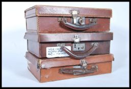 A selection of three vintage 20th Century brown leather travel briefcases having lined interiors