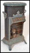 A 19th Century cast iron Petrolux stove heater, having stained glass canopy and enamel floral