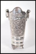A 20th Century silver plated wine cooler having repousse grape and floral decoration with twin