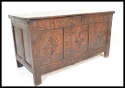A 17th / 18th century country oak large coffer chest. Raised on stile legs with wide and deep body