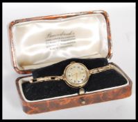 A vintage mid 20th Century hallmarked 9ct gold ladies cocktail watch by Lancet, champagne dial