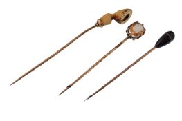 Three 19th century gold cravat stick pins. The pin