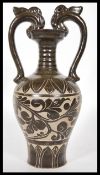 A Chinese stoneware vase / urn having shaped twin