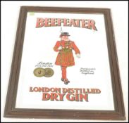 A 20th Century industrial shop / pub mahogany framed rectangular advertising wall mirror with