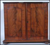 A VIctorian 19th century mahogany desk top specimen cabinet. Plinth base with bun feet to corners.