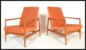 A pair of Danish style retro 20th Century open framed teak wood lounge / fireside armchairs each