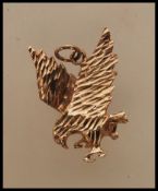 A 9ct gold pendant in the form of an eagle with en