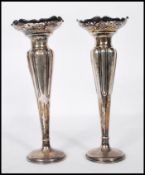 A pair of early 20th Century Art nouveau silver hallmarked spill vases of tapering form having