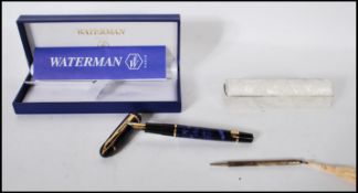 A cased Waterman fountain pen, the lidded pen having a blue marble finish with gilt metal