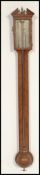 A 19th Century Georgian oak stick barometer. The silvered dial marked for J Powell Worcester. Having