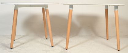 A contemporary white laminated and ash circular dining table. The table comprising of a laminated