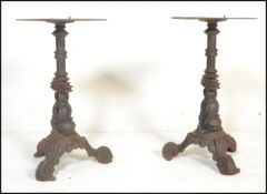 A pair of early 20th century garden / pub table of cast metal construction. Each base in the form of