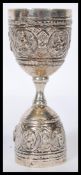 A Siam silver continental goose egg / duck cup combination bearing figures / deity cast in relief