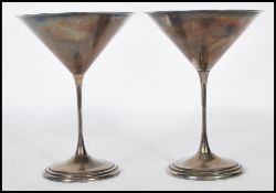 A pair of silver hallmarked cocktail, champagne, martini glasses, having shaped conical bowl with