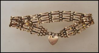 A 9ct gold hallmarked link bracelet with heart shaped clasp, Sheffield assay mark. 7