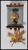 A hallmarked 9ct gold Masonic medal of Social Friendship, stamped to verso Presented to Bro: J.H.
