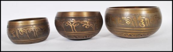 A group of three graduating bronze Tibetan singing