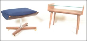 A vintage mid 20th century retro G-Plan stool of saddle form raised on an X base with chrome stem