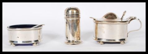 A silver hallmarked 3 piece condiment set comprising lidded and open pots, both with blue liners