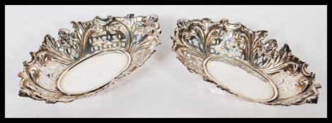 A pair of late Victorian silver hallmarked fret pierced lozenge shaped soap dishes. Each of rococo
