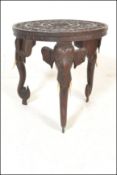 A late 19th / early 20th Century Anglo Indian highly carved circular tripod table supported by