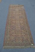 A large early 20th century handwoven Persian - Islamic runner rug having red ground with multiple