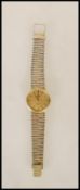 A vintage Longines Quartz slim line wrist watch having an oversized round face with gilt baton