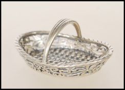 A silver 20th century miniature ladies garden basket having weave construction and arched handles.